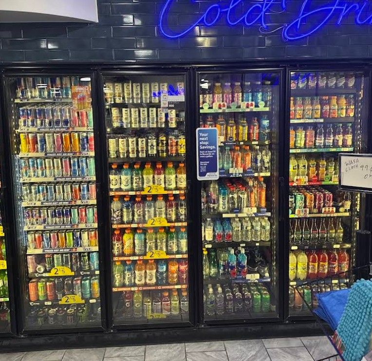 Commercial refrigeration technician servicing a walk-in cooler